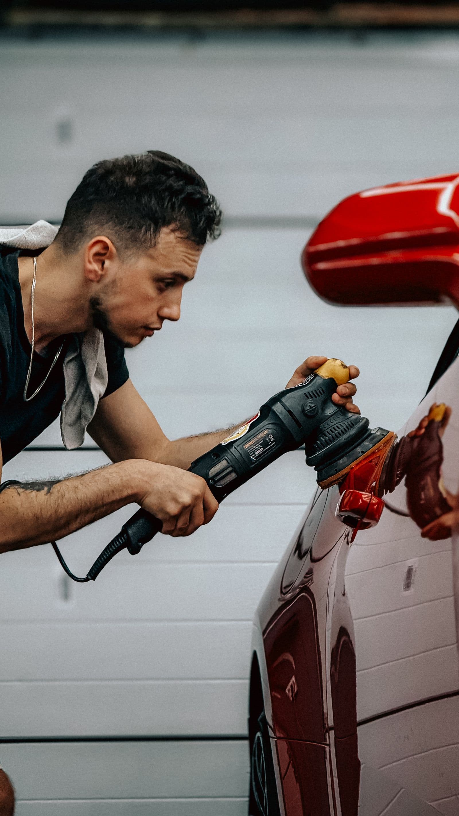 GlossLab detailer using a dual-action polisher to correct paint on a vehicle